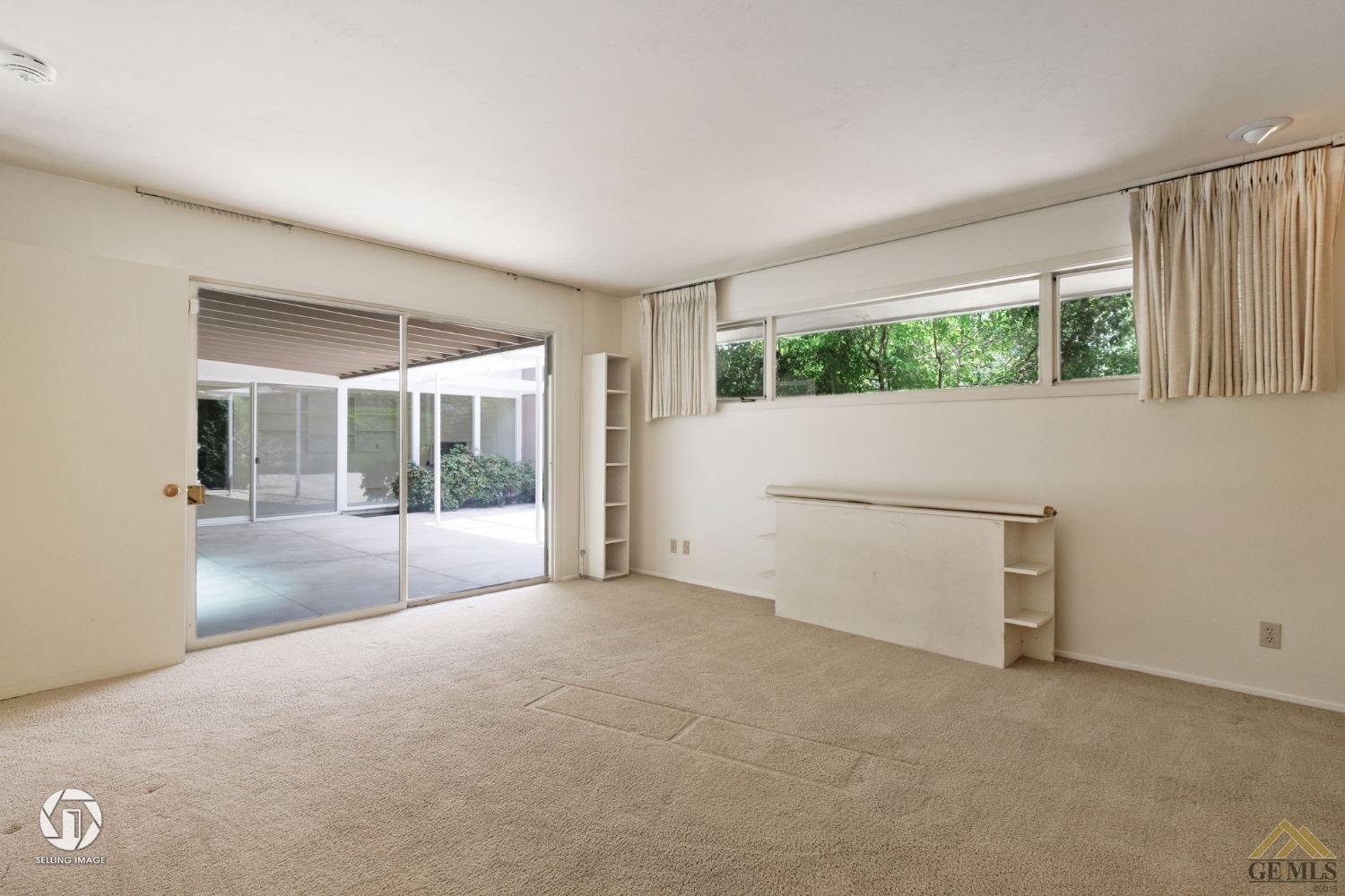 Undisclosed Address Bakersfield, CA 93309 - Photo 46 of 63 a view of an empty room with wooden floor and a window