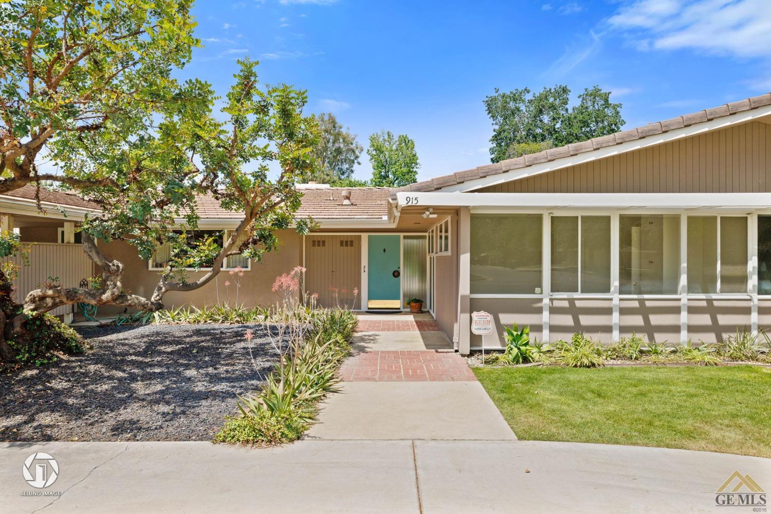 Undisclosed Address Bakersfield, CA 93309 - Photo 9 of 63 a front view of a house with a garden