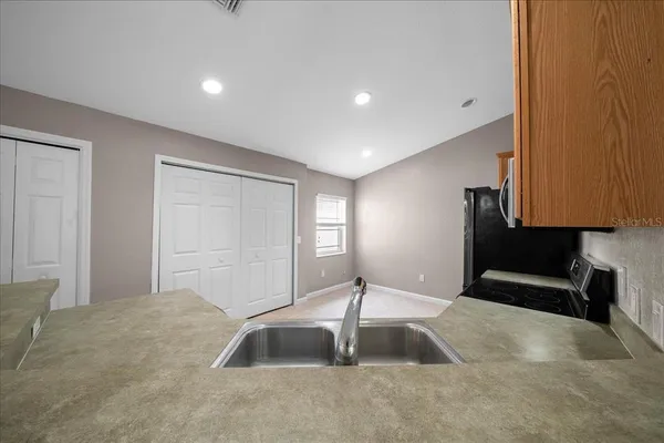 an empty room with windows and fan