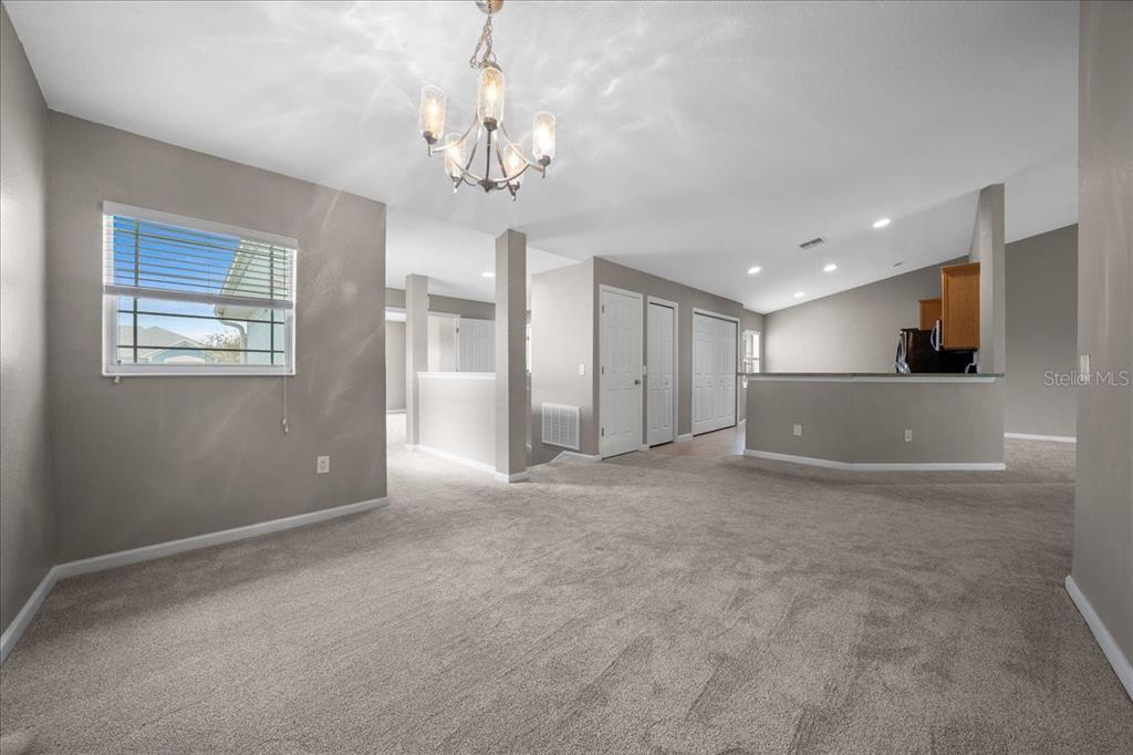 4555 Southwest 52nd Circle, Unit 106 Ocala, FL 34474 - Photo 15 of 100 a view of a livingroom with a chandelier furniture and windows
