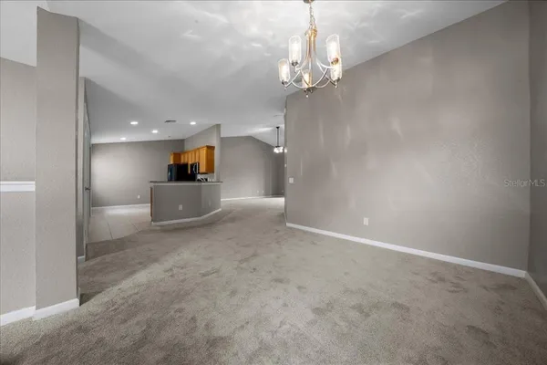 an empty room with closet and a ceiling fan