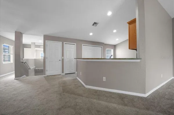 an empty room with windows and closet