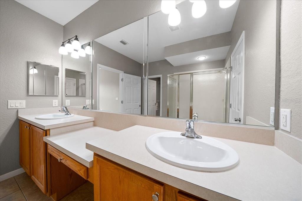 4555 Southwest 52nd Circle, Unit 106 Ocala, FL 34474 - Photo 26 of 100 a bathroom with a sink and a mirror