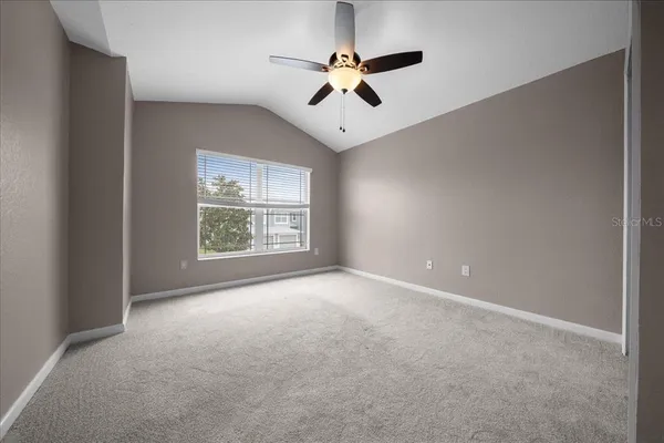 a dining room with furniture and a floor to ceiling window