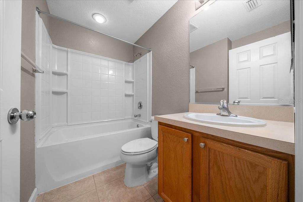 4555 Southwest 52nd Circle, Unit 106 Ocala, FL 34474 - Photo 37 of 100 a bathroom with a granite countertop sink a toilet and shower