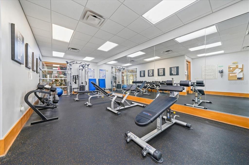 4555 Southwest 52nd Circle, Unit 106 Ocala, FL 34474 - Photo 49 of 100 a room with gym equipment and mirrors