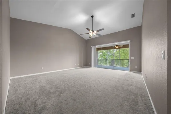 a view of a livingroom with a chandelier furniture and windows