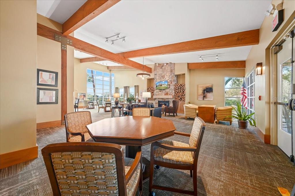 4555 Southwest 52nd Circle, Unit 106 Ocala, FL 34474 - Photo 61 of 100 a dining room with furniture and a floor to ceiling window