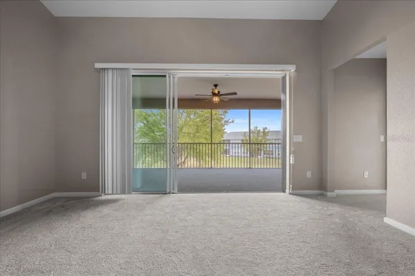 a view of a livingroom with a ceiling fan and window