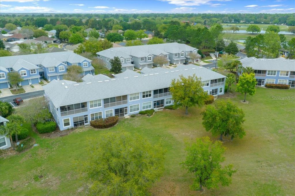 4555 Southwest 52nd Circle, Unit 106 Ocala, FL 34474 - Photo 84 of 100 an aerial view of a house with yard and green space