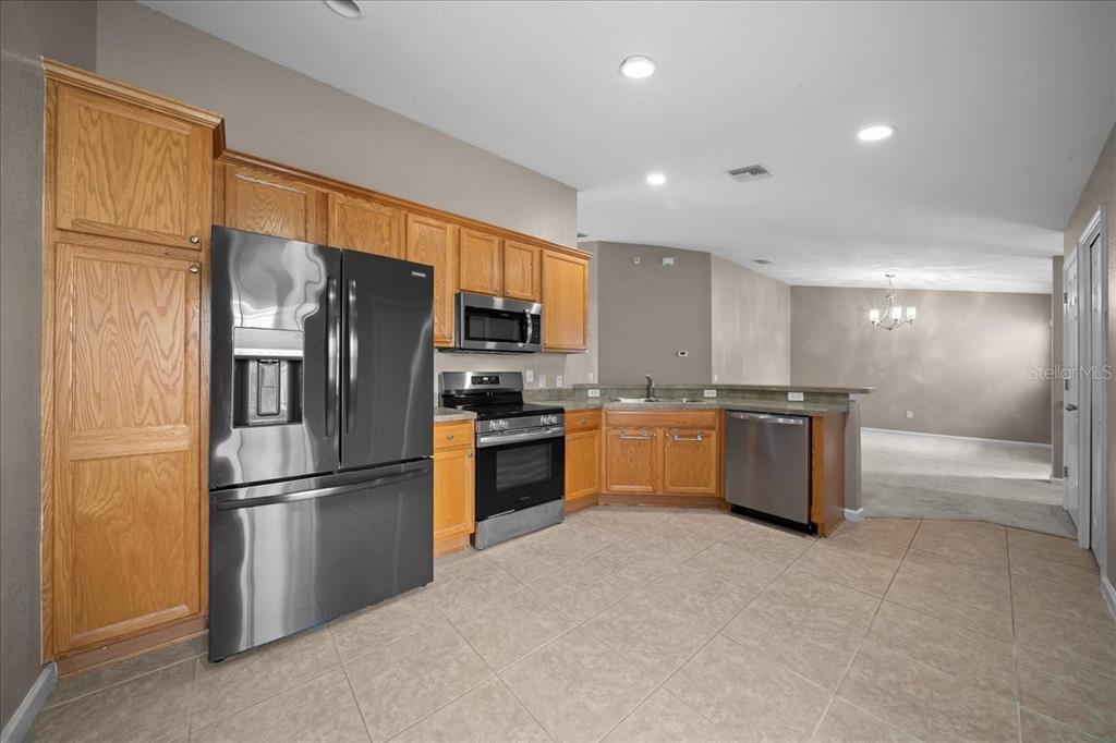 4555 Southwest 52nd Circle, Unit 106 Ocala, FL 34474 - Photo 9 of 100 a kitchen with stainless steel appliances a refrigerator and a sink
