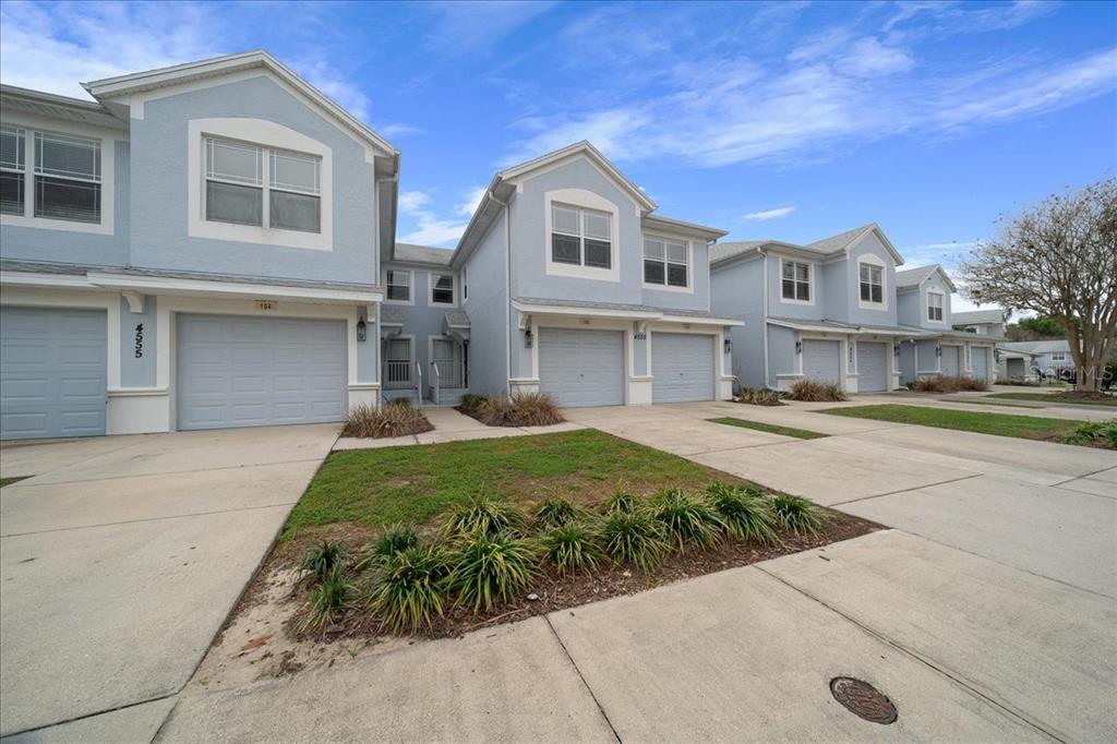 4555 Southwest 52nd Circle, Unit 106 Ocala, FL 34474 - Photo 91 of 100 a front view of a house with a garden