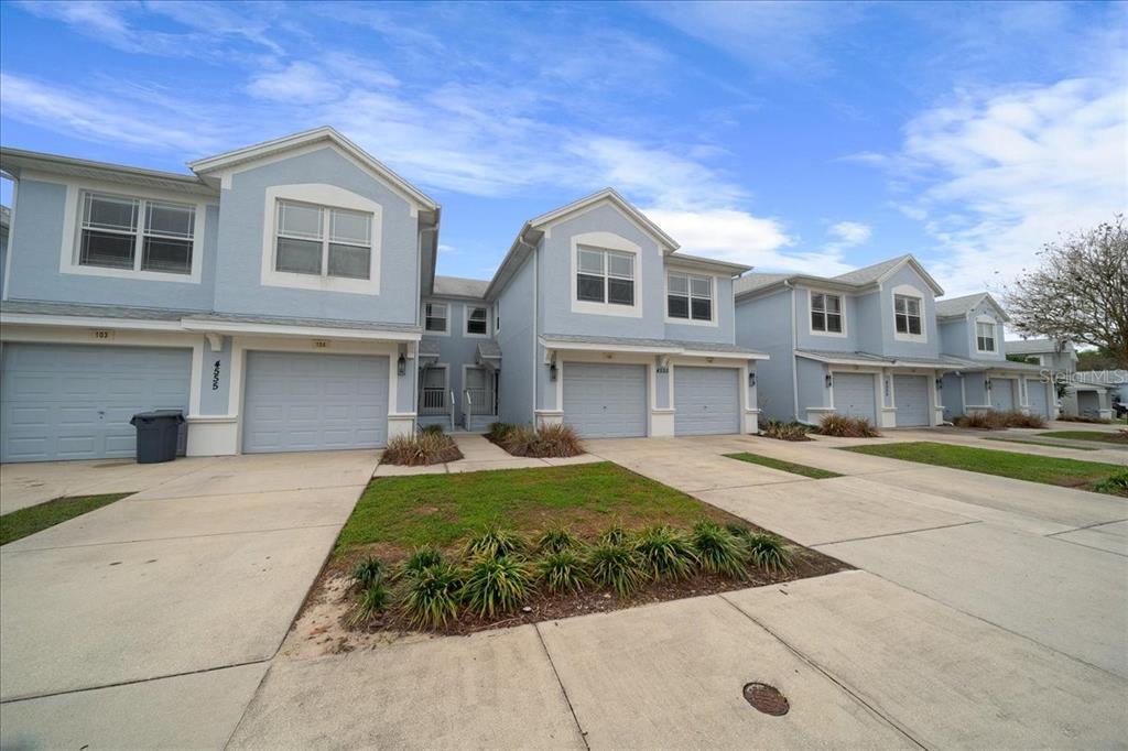 4555 Southwest 52nd Circle, Unit 106 Ocala, FL 34474 - Photo 92 of 100 a front view of a house with a yard