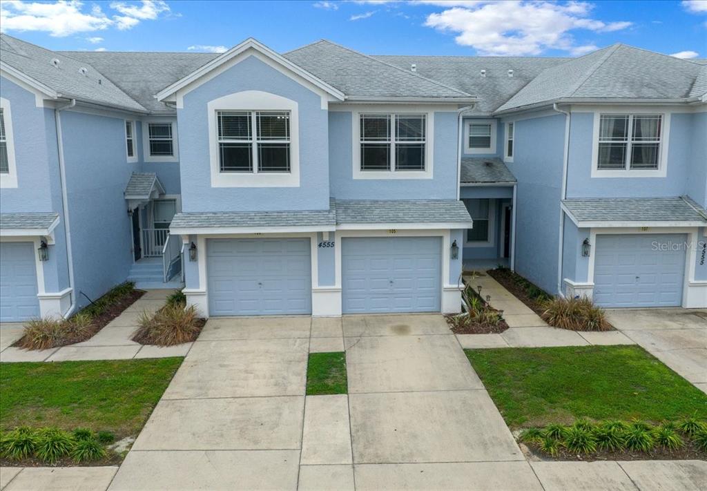 4555 Southwest 52nd Circle, Unit 106 Ocala, FL 34474 - Photo 94 of 100 a front view of a house with a yard and garage