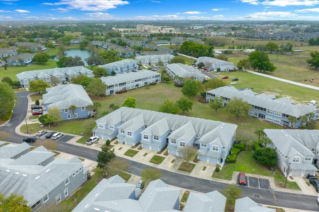 4555 Southwest 52nd Circle, Unit 106 Ocala, FL 34474 - Photo 98 of 100 an aerial view of a house with a big yard