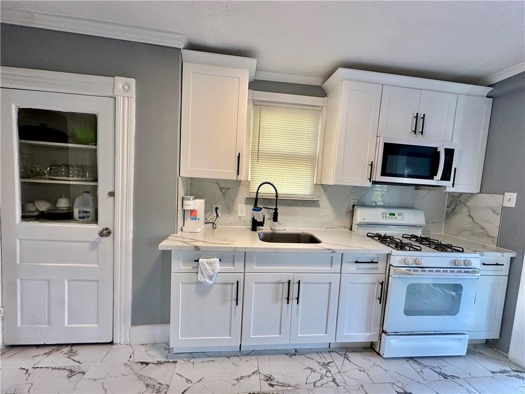 94 Lafferty Avenue Pittsburgh, PA 15210 - Photo 15 of 35 a kitchen with a sink stove and microwave