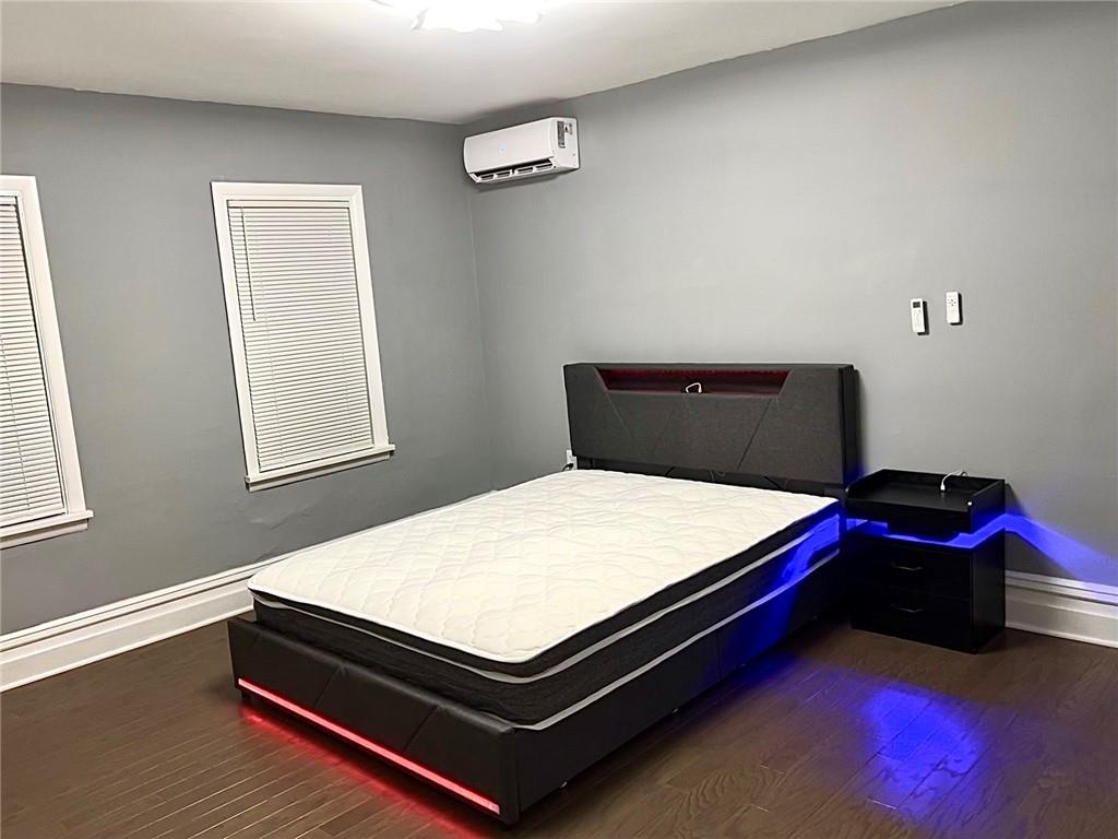 94 Lafferty Avenue Pittsburgh, PA 15210 - Photo 24 of 35 a bed sitting in a bedroom next to a window