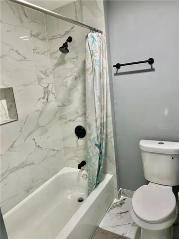 a bathroom with a toilet sink and shower