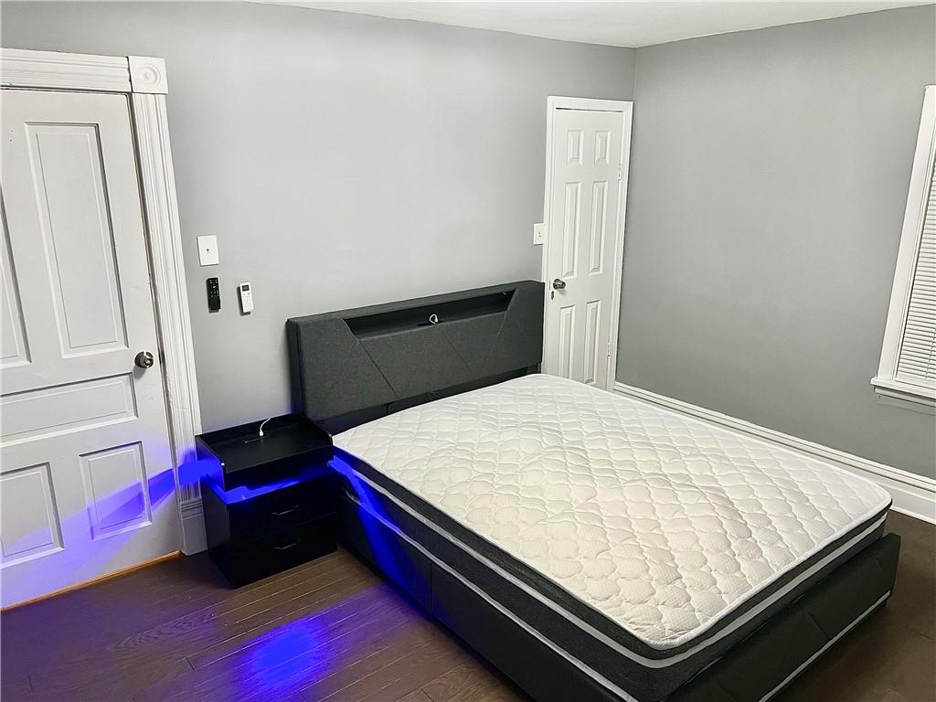 94 Lafferty Avenue Pittsburgh, PA 15210 - Photo 27 of 35 a bed sitting in a bedroom next to a window