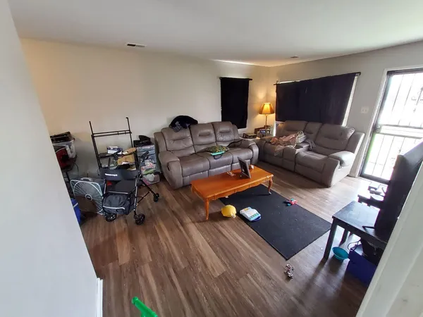 a living room with furniture a rug and a window