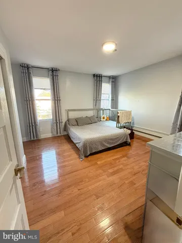 a bedroom with double vanity and a bed