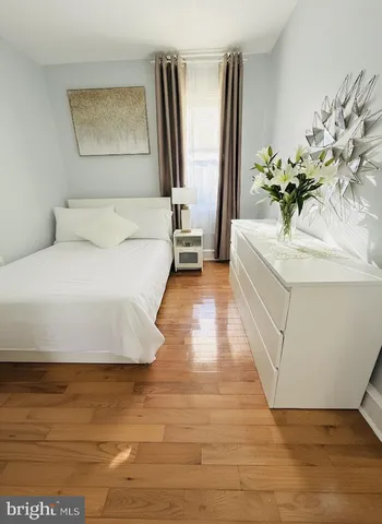 a bathroom with a bathtub and a potted plant