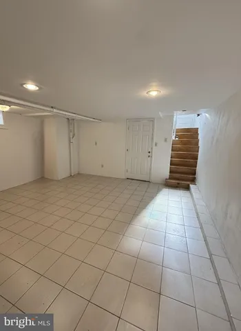 a view of an empty room and staircase