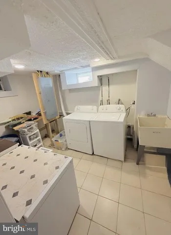 a bathroom with a sink a toilet a tub and shower