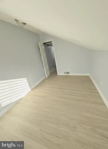 a bed sitting in a room next to a window