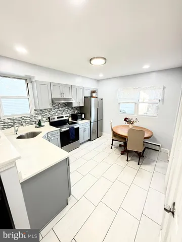 a kitchen with stainless steel appliances kitchen island granite countertop a sink and cabinets