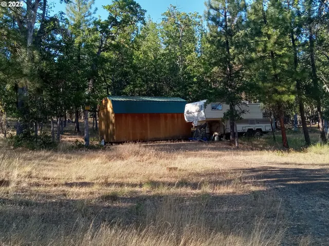 a backyard of a house with barbeque oven table and chairs