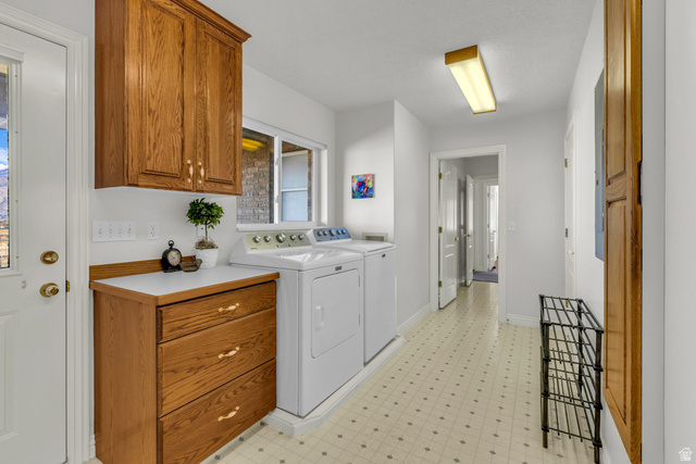 1060 West 2620th Street South Mapleton, UT 84664 - Photo 48 of 87 Laundry area with light flooring, washing machine and clothes dryer, and cabinet space