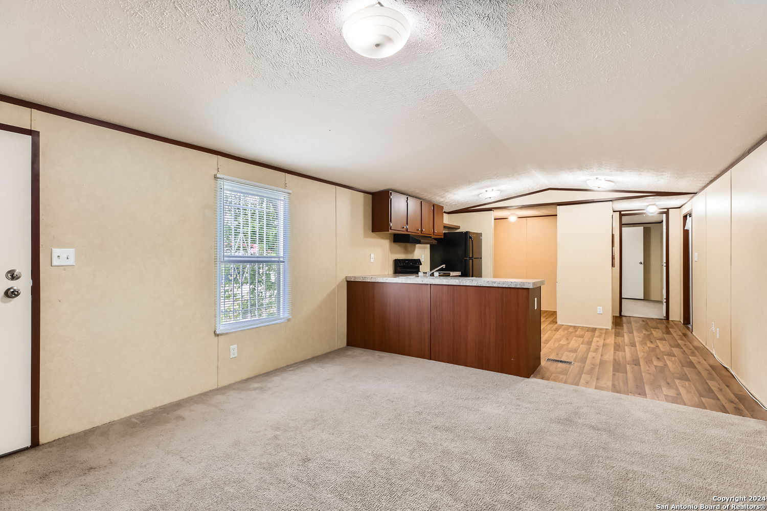 4423 East Houston Street San Antonio, TX 78219 - Photo 4 of 11 wooden floor in an empty room with a window