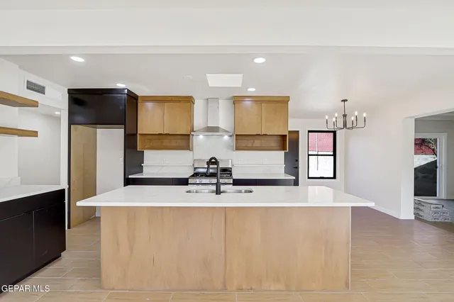 a large kitchen with kitchen island a sink stainless steel appliances and cabinets