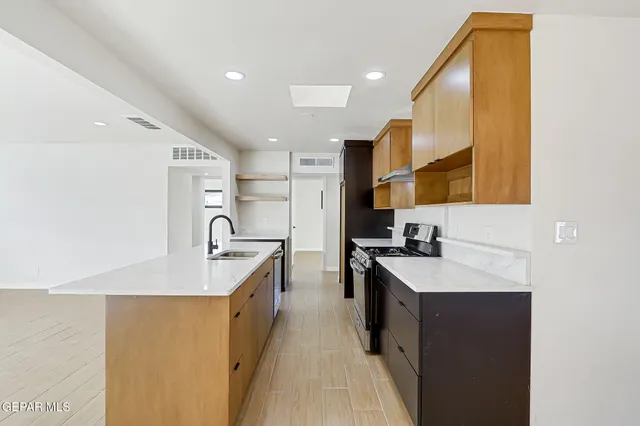 a kitchen with sink and cabinets
