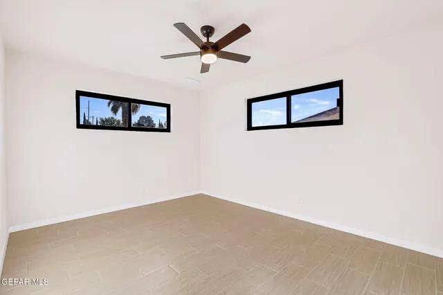 an empty room with a ceiling fan