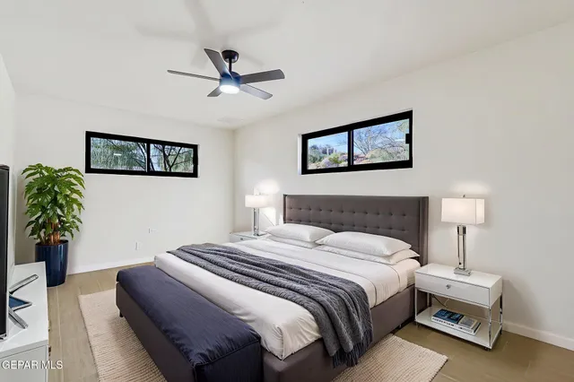 a bedroom with a bed and a painting on the wall