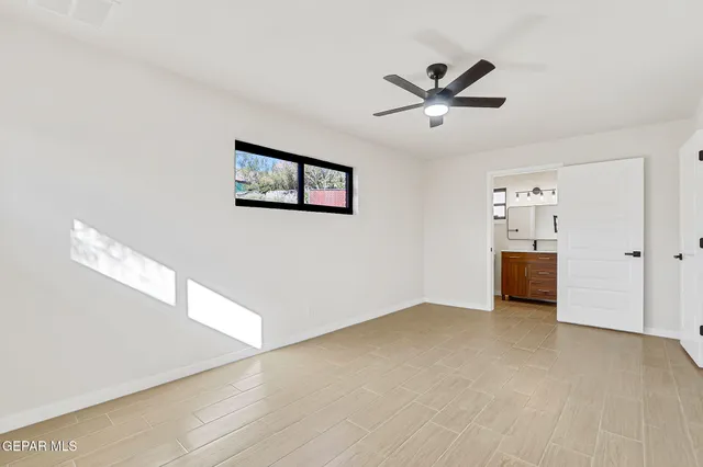 a view of a livingroom with a ceiling fan and window