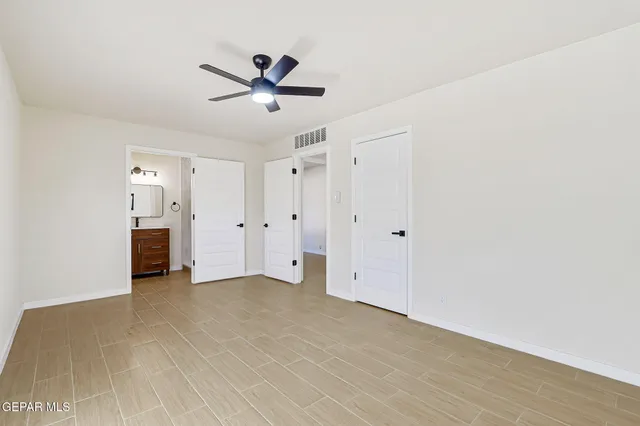 a view of empty room with ceiling fan