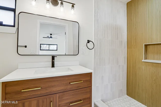 a bathroom with a sink and mirror
