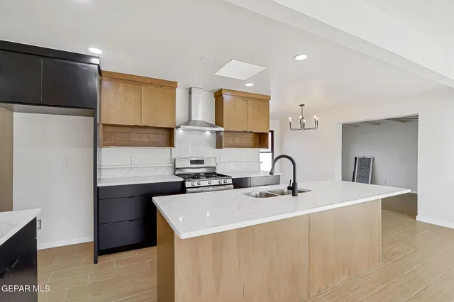 a kitchen with a sink a stove and refrigerator