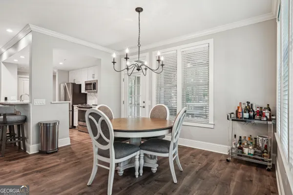 a view of a dining room with furniture large windows and wooden floor