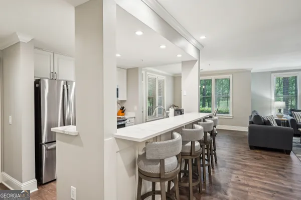 a kitchen with stainless steel appliances a stove a sink and a refrigerator