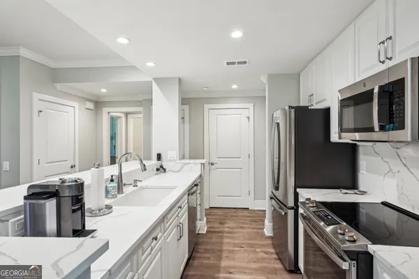 a kitchen with sink and refrigerator