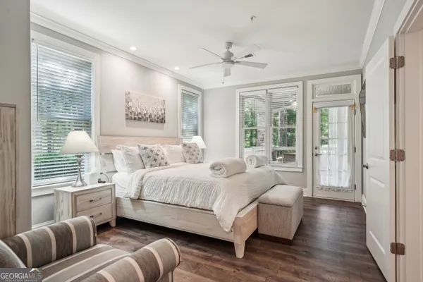 a bedroom with a large bed and a chandelier