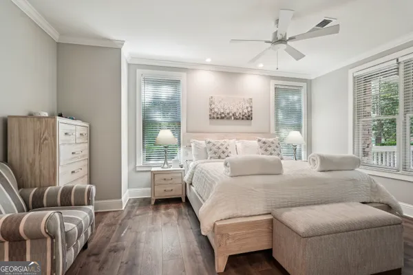 a bedroom with a large bed and a large window