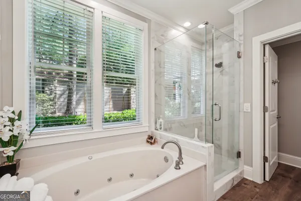 a white bath tub sitting in a bathroom next to a window