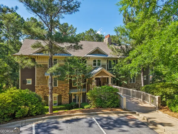 an aerial view of a house with a yard and lake view