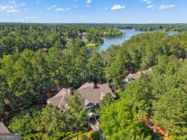 an aerial view of a houses with outdoor space and lake view