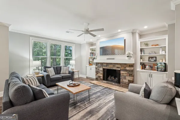 a living room with furniture and a fireplace